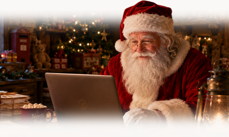 Santa at his laptop in his cosy North Pole study